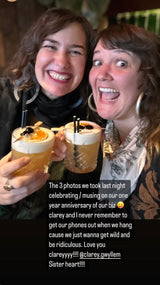 Two people celebrating a one-year anniversary with drinks, text overlay on a dark background